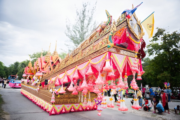 Ornate float decorated with flowers and gold details during the Bun Bang Fai Rocket Festival in Thailand