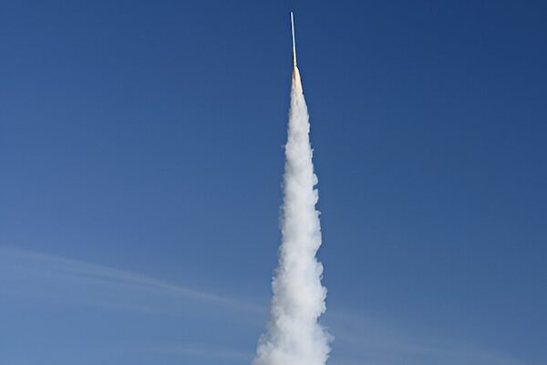 Handmade rocket launching high into the blue sky during the Bun Bang Fai Rocket Festival in Thailand