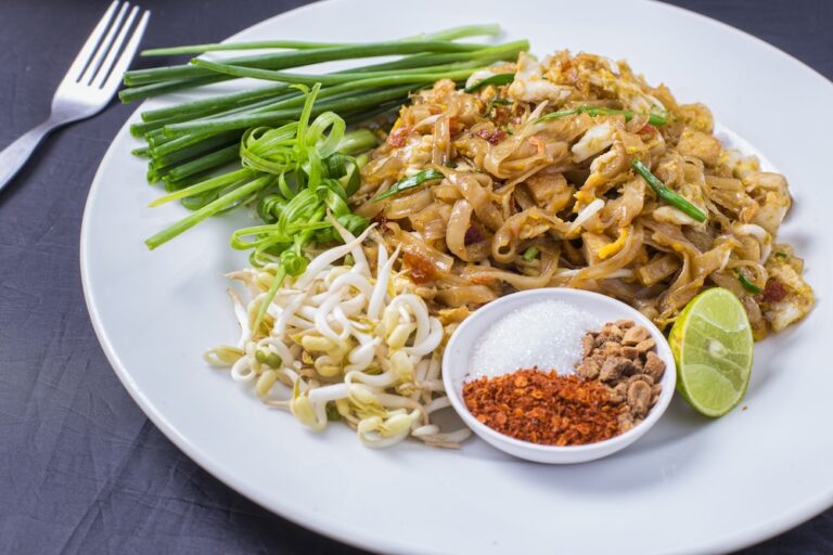 traditional Thai dish served with peanuts, lime, and fresh herbs