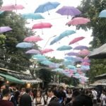 Shopping in Thailand at Chatuchak Market under colorful umbrellas