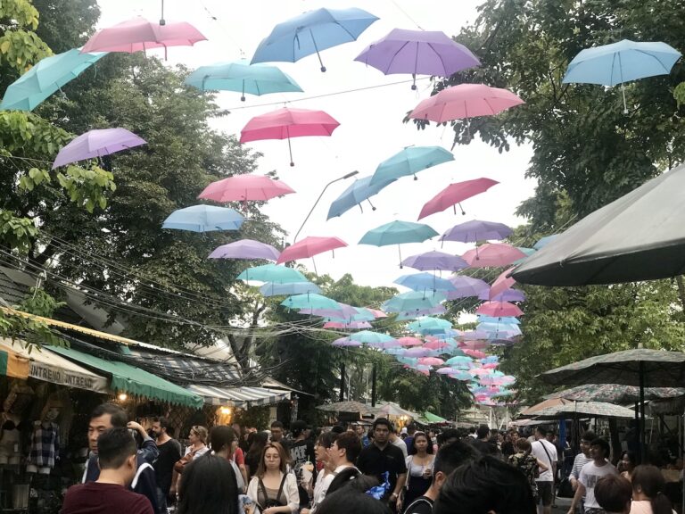 Shopping in Thailand at Chatuchak Market under colorful umbrellas