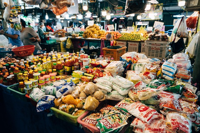 Assortment of packaged noodles, spices and sauces on display at a bustling local market in Thailand