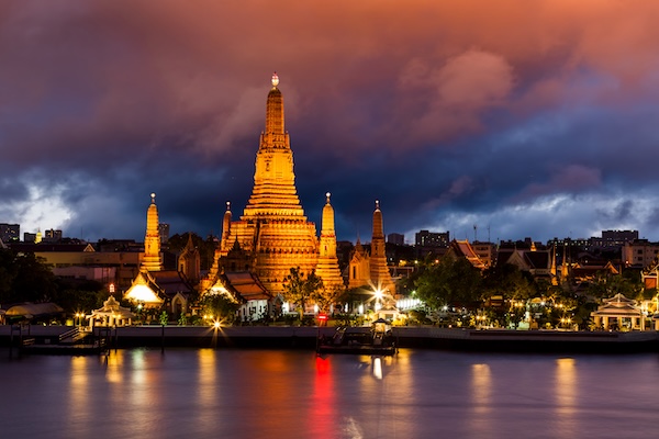 Wat Arun temple illuminated at sunset in Bangkok during Visakha Bucha in Thailand