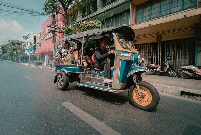 A tuk-tuk carrying tourists in Bangkok, often linked to common scams involving fake temple closures and overpriced shop stops