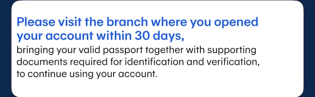 Notice received when a Bangkok Bank account frozen, requiring a branch visit with a passport for verification.