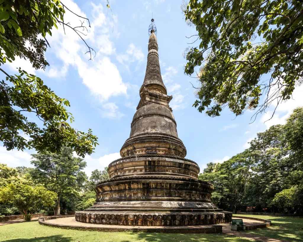 The old chedi of Wat Umong surrounded by trees in Chiang Mai.