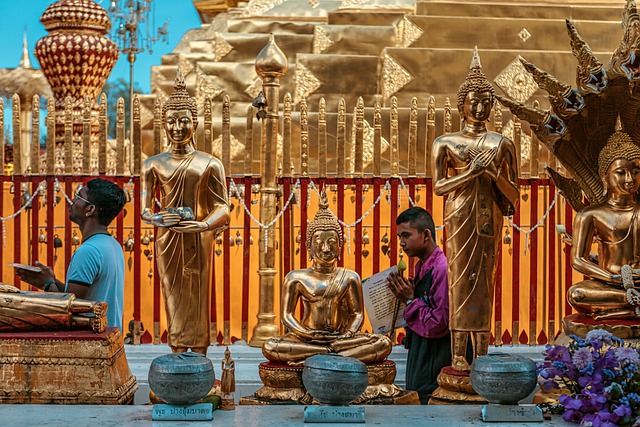 Statues de Bouddha dorées et fidèles en prière au temple Doi Suthep de Chiang Mai