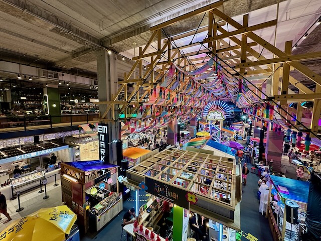 Vue d'ensemble d'un food court animé et coloré dans un centre commercial de Bangkok, une activité idéale quand il pleut en Thaïlande.