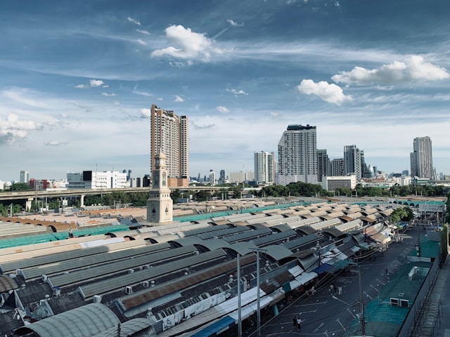 Vue aérienne du marché de Chatuchak avec les toits ondulés et la skyline de Bangkok à l’arrière-plan