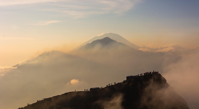 Randonneurs au lever du soleil sur un volcan en Indonésie au-dessus des nuages