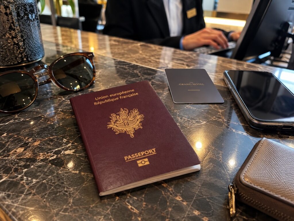 Passeport français posé sur le comptoir de réception d'un hôtel